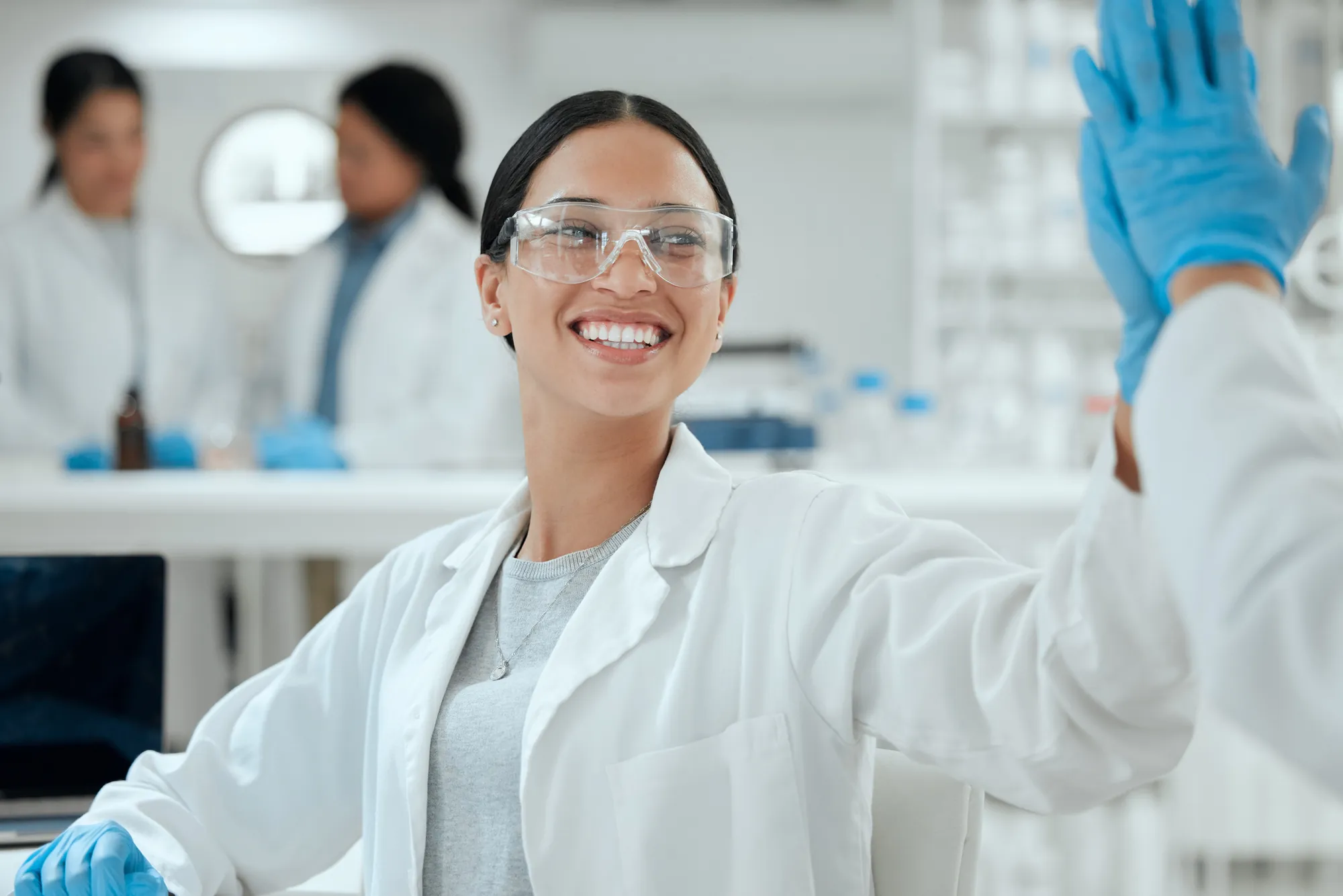Researchers celebrating a result in a university laboratory