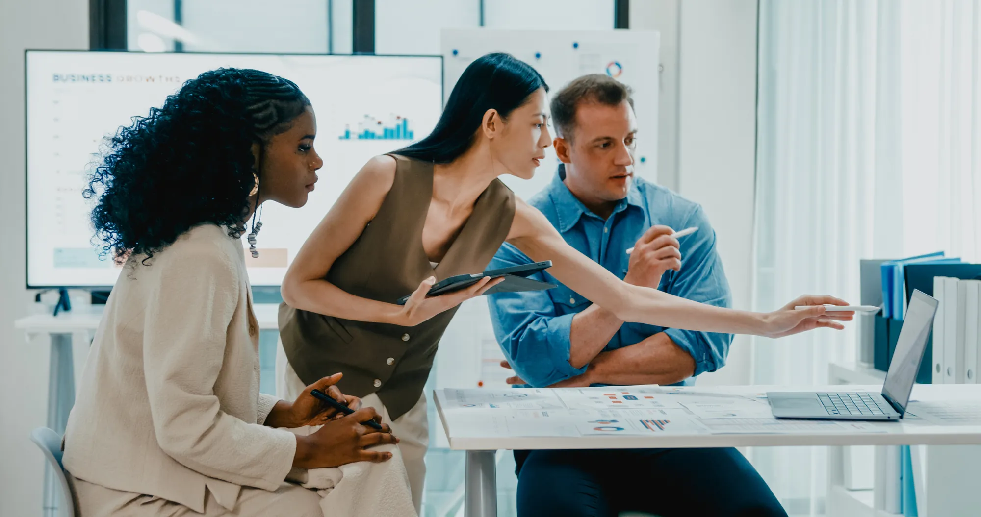 Consultants collaborating around a desk